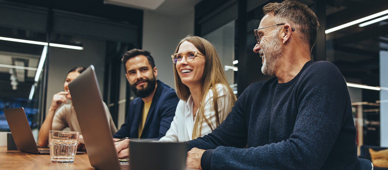 Group of business people sitting around a table.