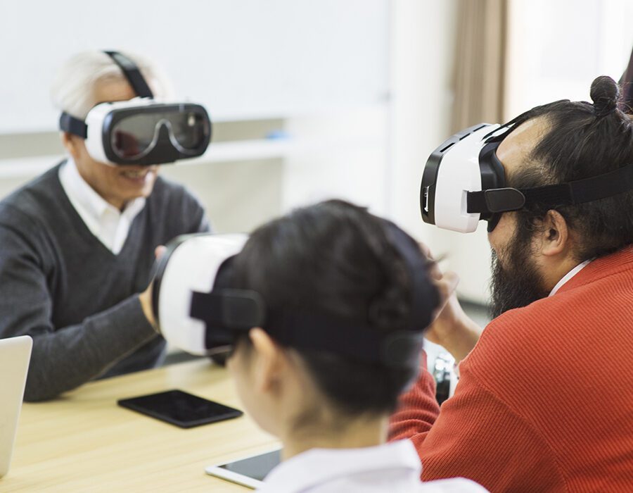 Group of people with Virtual reality headsets meeting together.