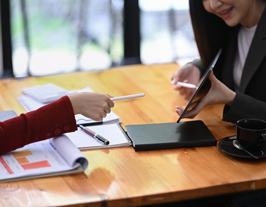 Two colleagues discussing information on digital tablet.