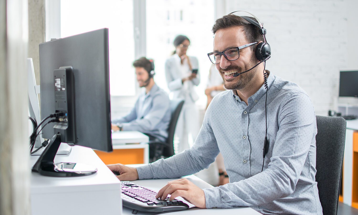 Person wearing headset working in the office.