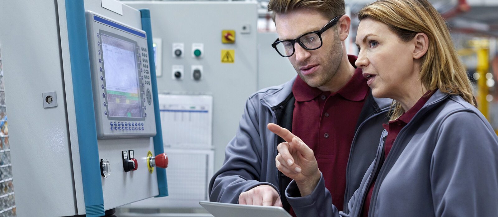 Two engineers with tablet computer in plant.