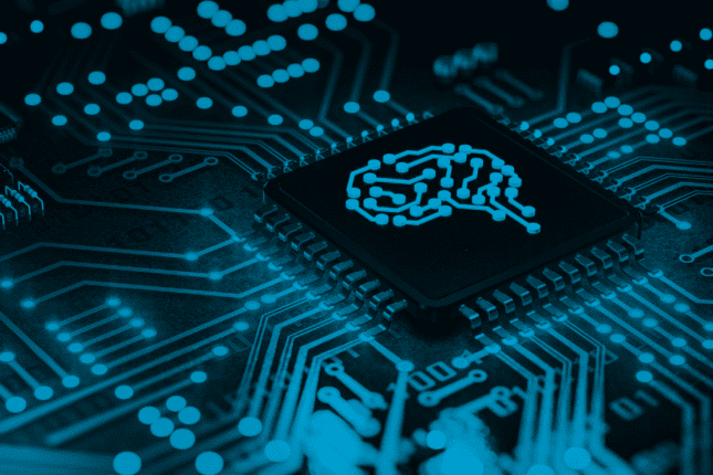 Closeup of a circuit board with a brain logo imprinted on the CPU.