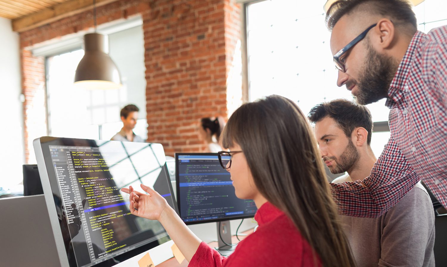 Colleagues reviewing monitor content.