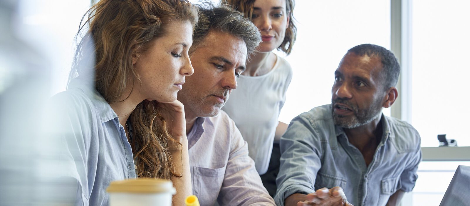 Group of colleagues reviewing and discussing a document