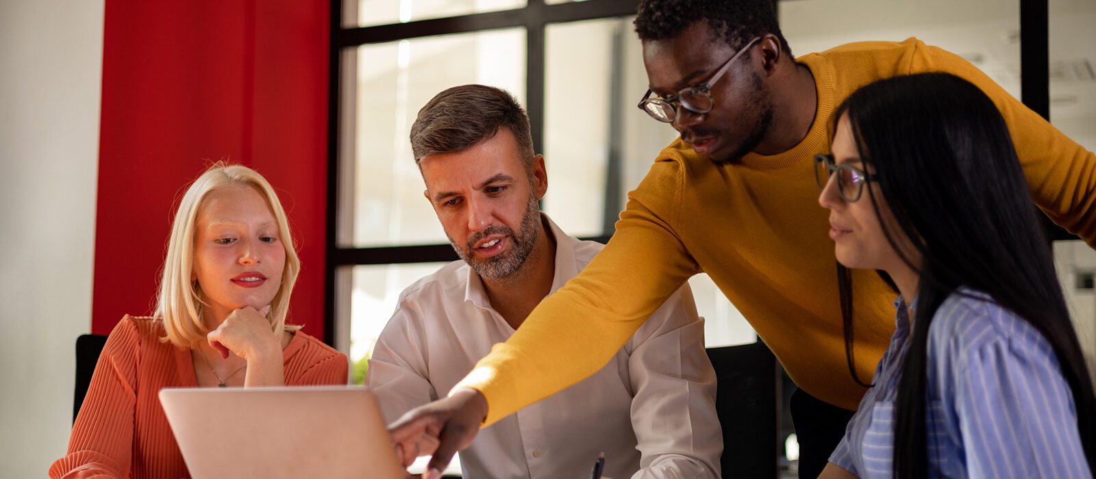 Team member directing team to laptop screen