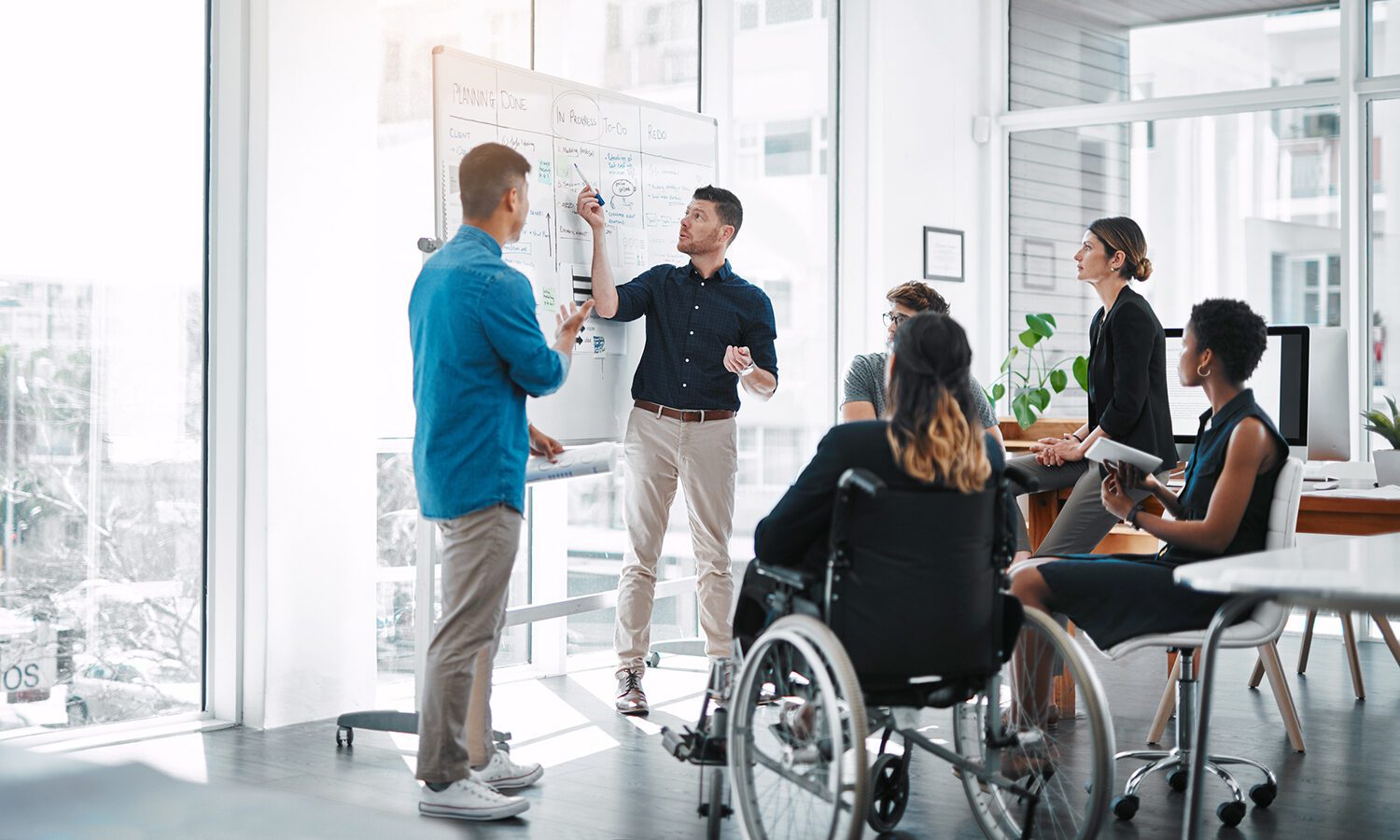 Team of business people meeting at a whiteboard