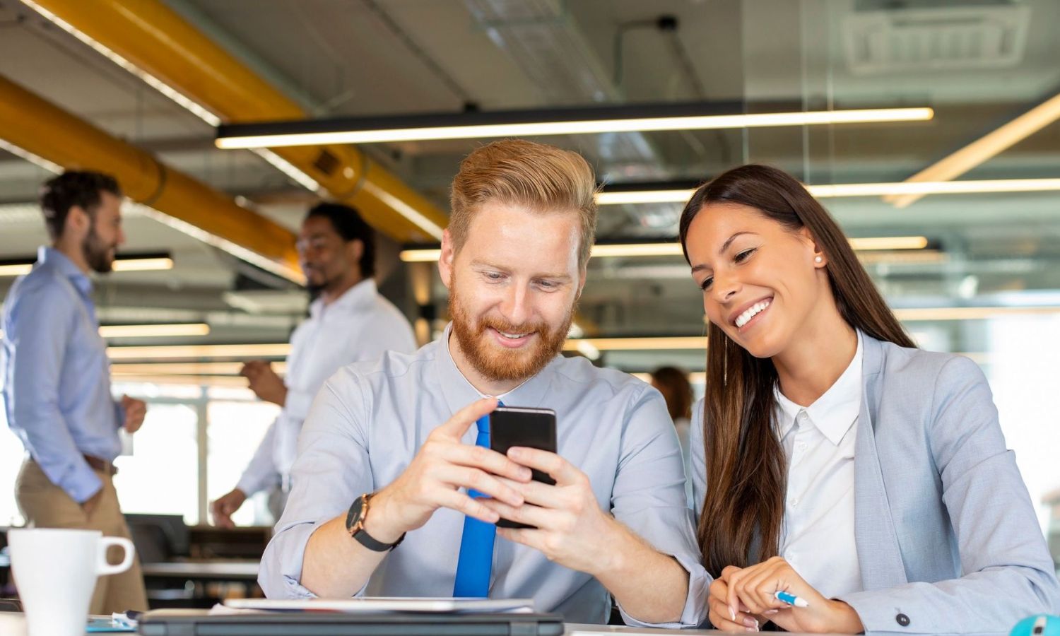coworkers smiling on mobile device